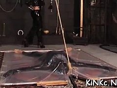 Femdom dominatrix wraps up her slave in bondage and tortures his cock