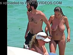 MILF with hairy bush and armpits takes her top off on a beach