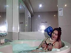 Mature woman enjoys footjob from young penguin in jacuzzi