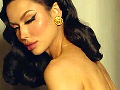 Sultry brunette milf, Bryona Ashly, performs a seductive solo striptease in a softcore video that highlights her mature beauty and voluptuous figure.
