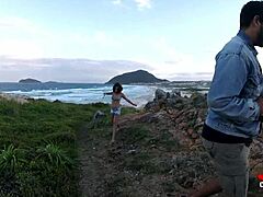 Video membangkitkan seorang gadis muda memberikan blowjob di atas batu di tepi laut